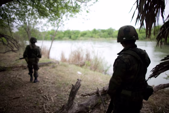 Image: Mexican soldiers patrol along the bank of the Bravo river near Los Guerra, on Mexico's northeastern border with the U.S.